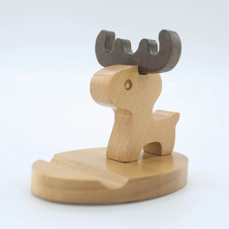 Beech wood and resin lazy bracket mobile phone holder in an animal design style on a desk.