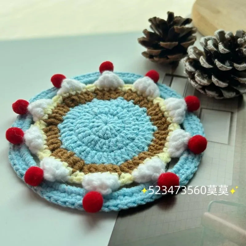 Round 9cm grey felted wool coaster next to its drawstring storage pouch.