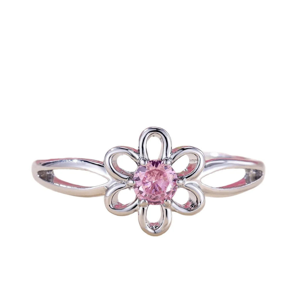 Women's hollowed flower fashion ring in electroplated platinum pink diamond colour on a white background.