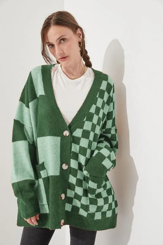 Loose fit knitwear cardigan with checks print in a selection of colours on a hanger.