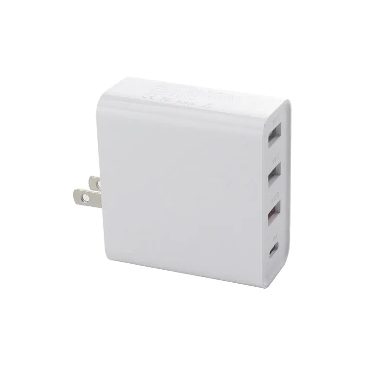 Black and white four-port USB-C wall charger with interchangeable UK, US, EU, and AU plug heads.