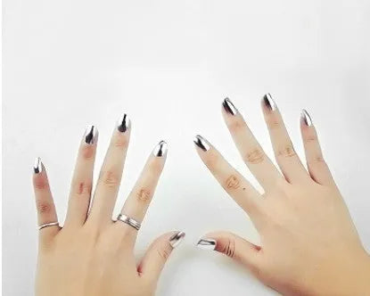 Bottle of mirror silver nail polish with brush and stainless-steel ball for mixing