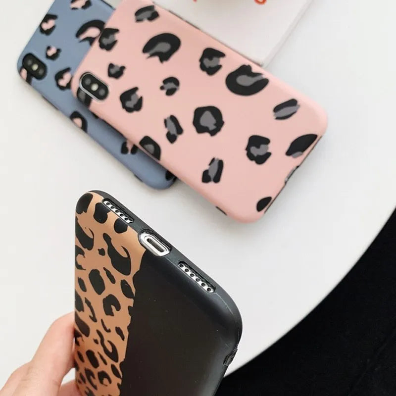 Leopard print mobile phone case for iPhone in black, blue, and pink colours