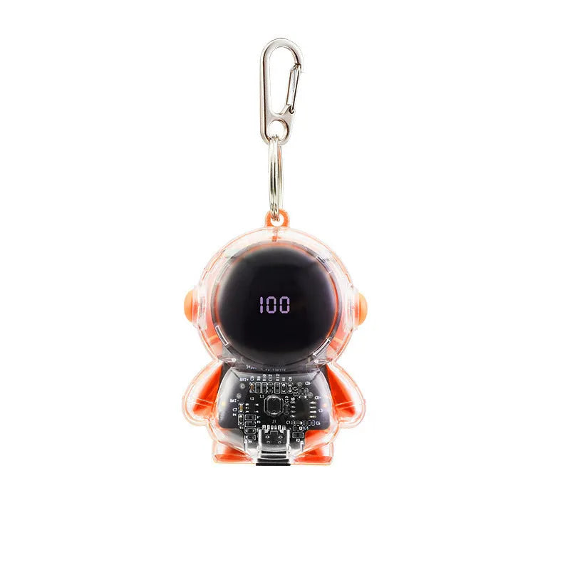 Small keychain emergency power bank in orange plastic shell with cartoon-style design and keyring attachment