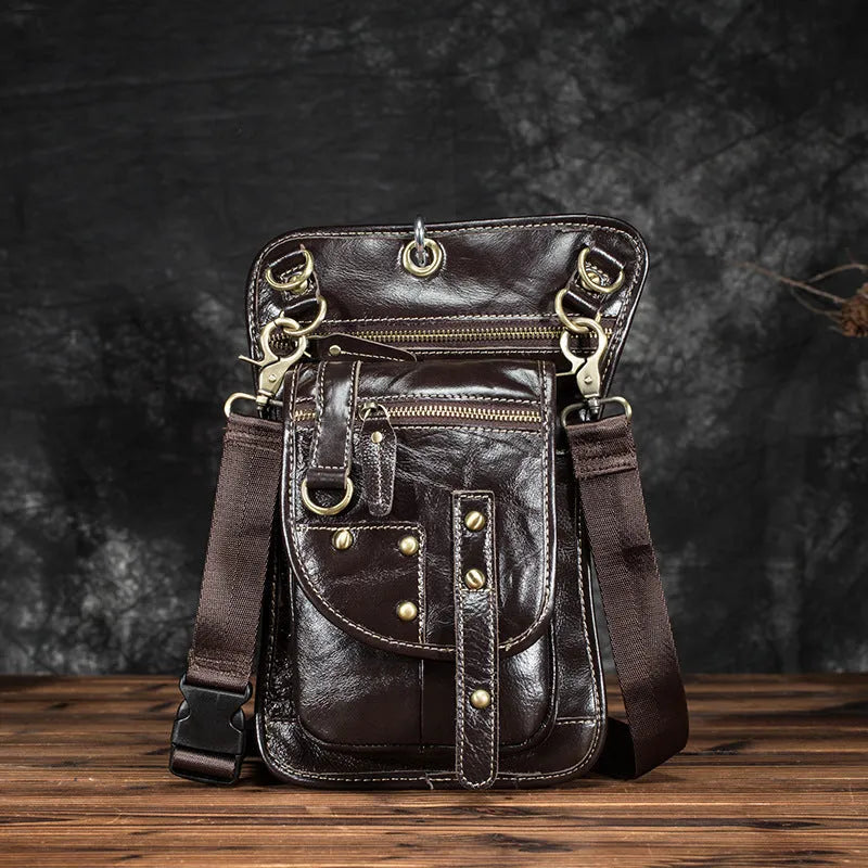 Men's punk fanny pack made from genuine cowhide leather with zipper closure and internal pockets, on display