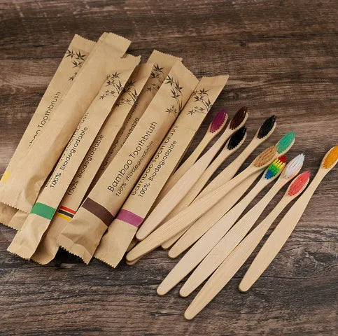 Set of 10 bamboo toothbrushes in multiple colours showing natural bamboo handles and soft bristles