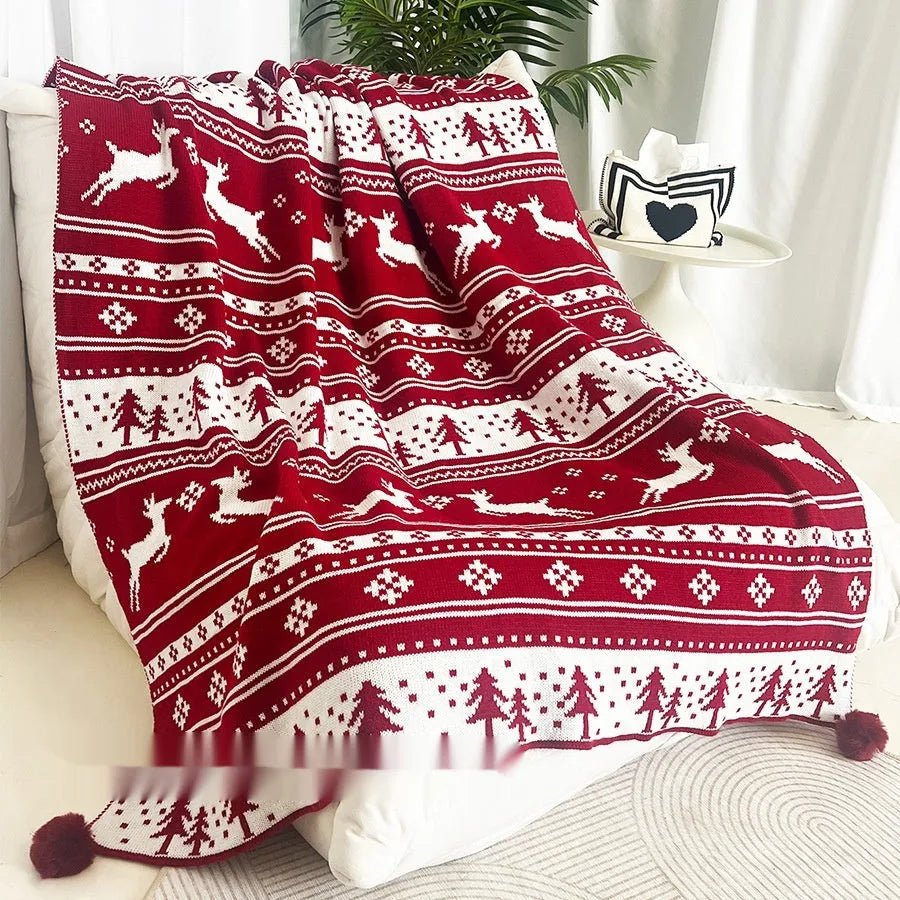 Christmas acrylic blanket with snowflake pattern in 110x130cm size on sofa