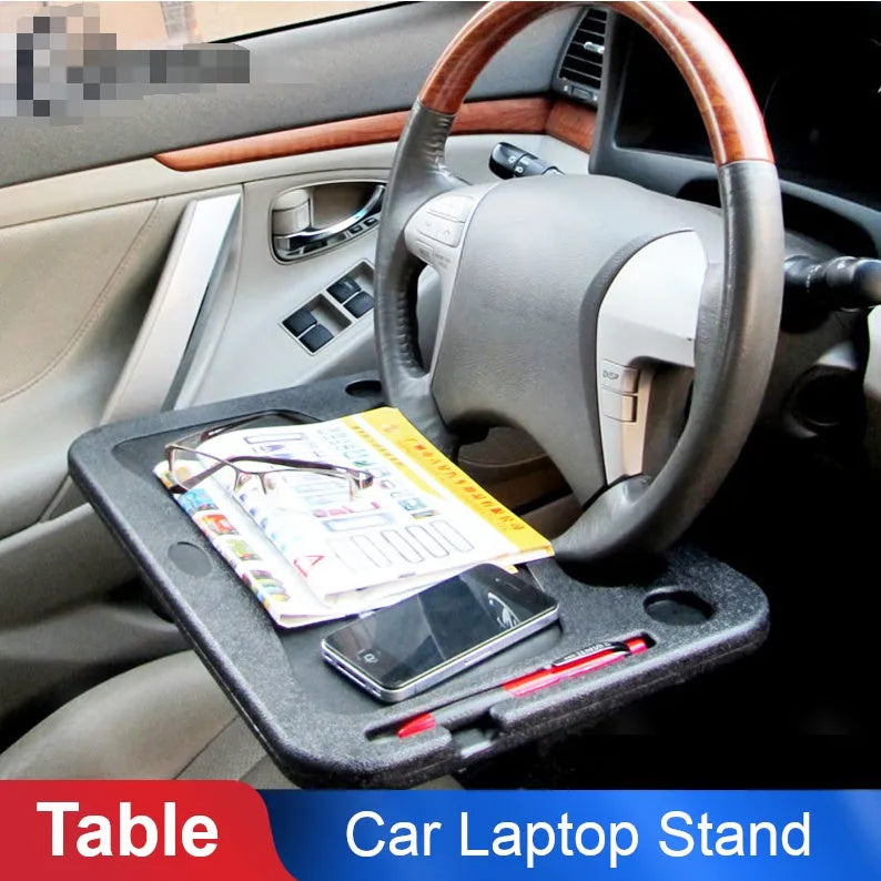 Multifunctional car desk in grey ABS with full suspension structure mounted on a car steering wheel, showing the adjustable angle handle