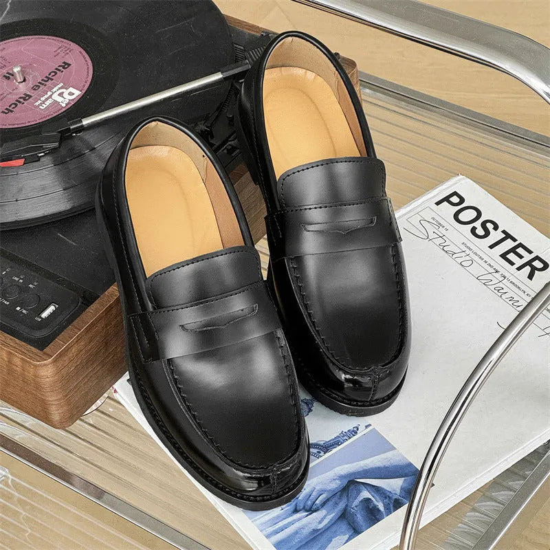 Black men's classic slip-on derby leather shoes with a rubber sole, shown in a mature style.