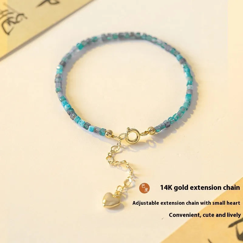 Women's natural blue apatite crystal bracelet with diamond-cut facets on adjustable band