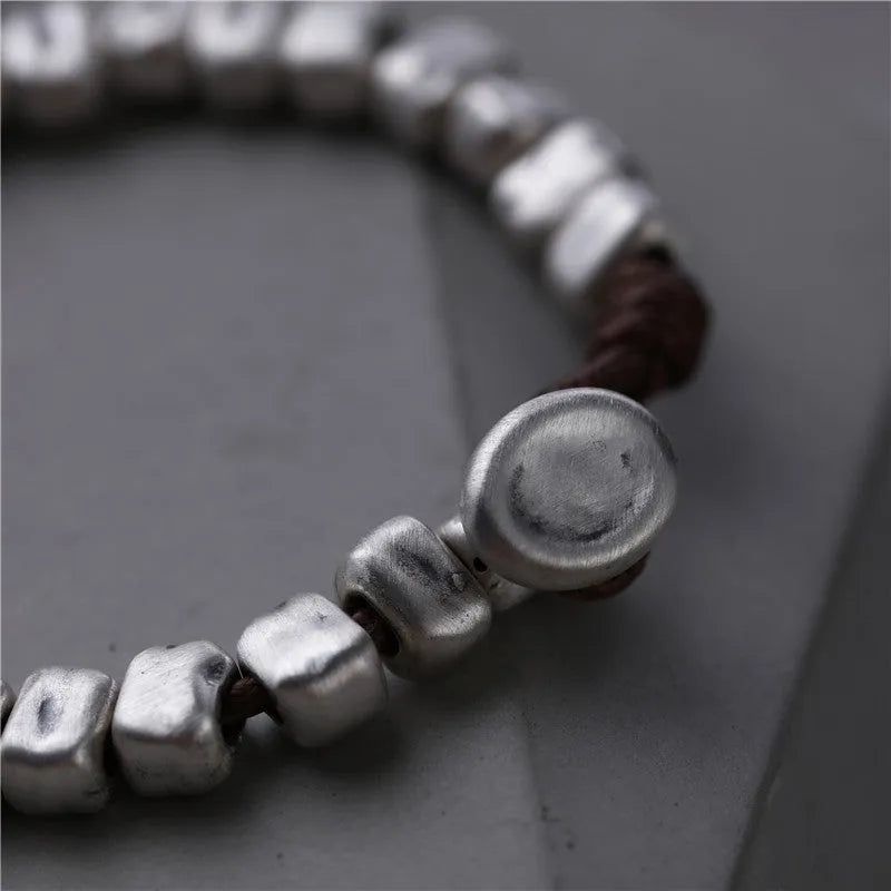 Handmade women's bracelet with irregular square design in wood and silver materials on elastic band