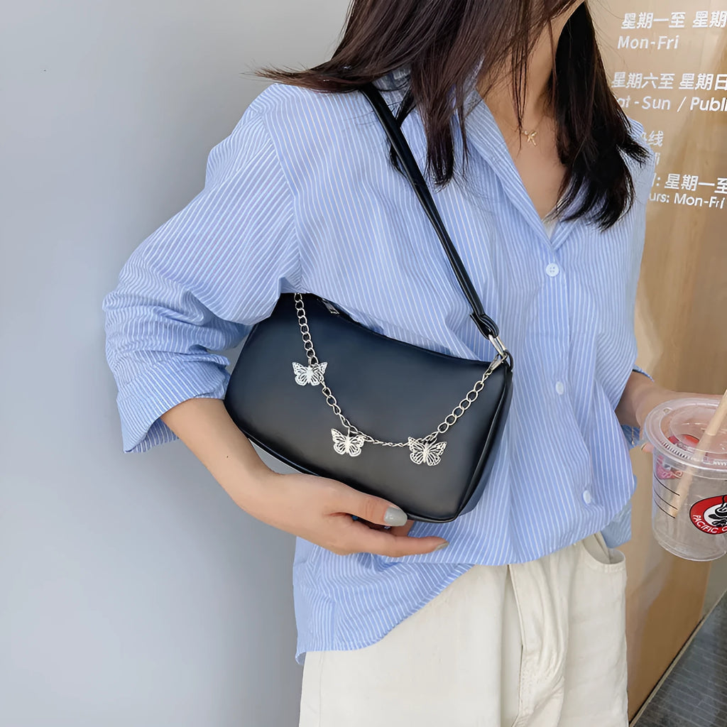 Women's black retro-style crossbody bag with chain strap and structured square shape.