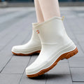 Women's short plastic waterproof rubber shoes in black, shown on a white background.