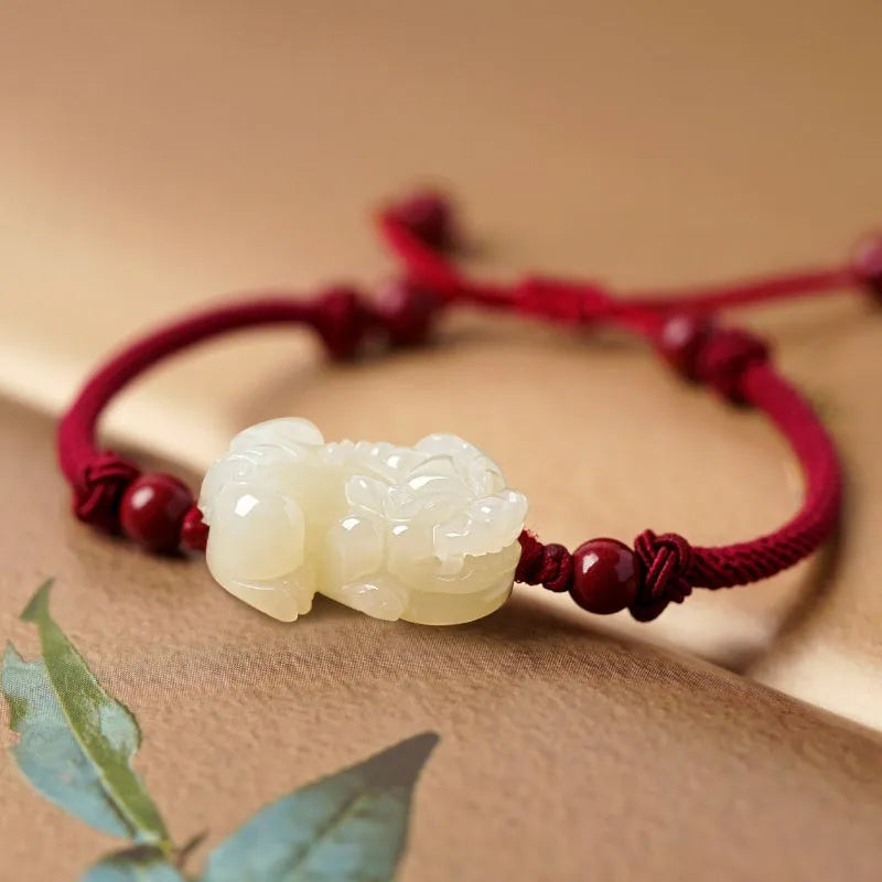 Traditional Chinese Hetian jade bracelet with black and red braided ropes and jade beads on elastic cord