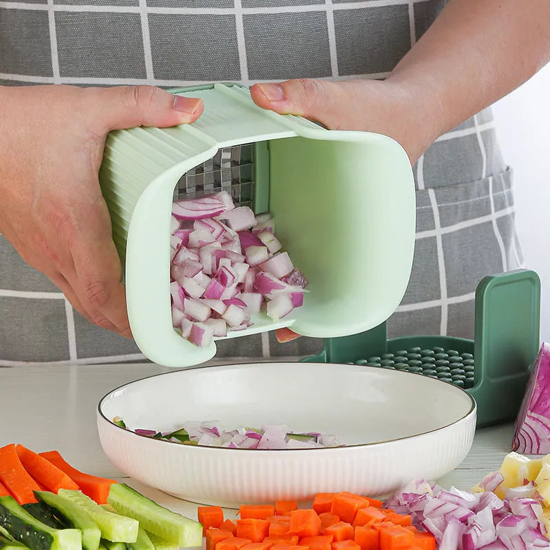 Green manual vegetable chopper with stainless steel cutting grid for slicing onions, potatoes, radishes and cucumbers
