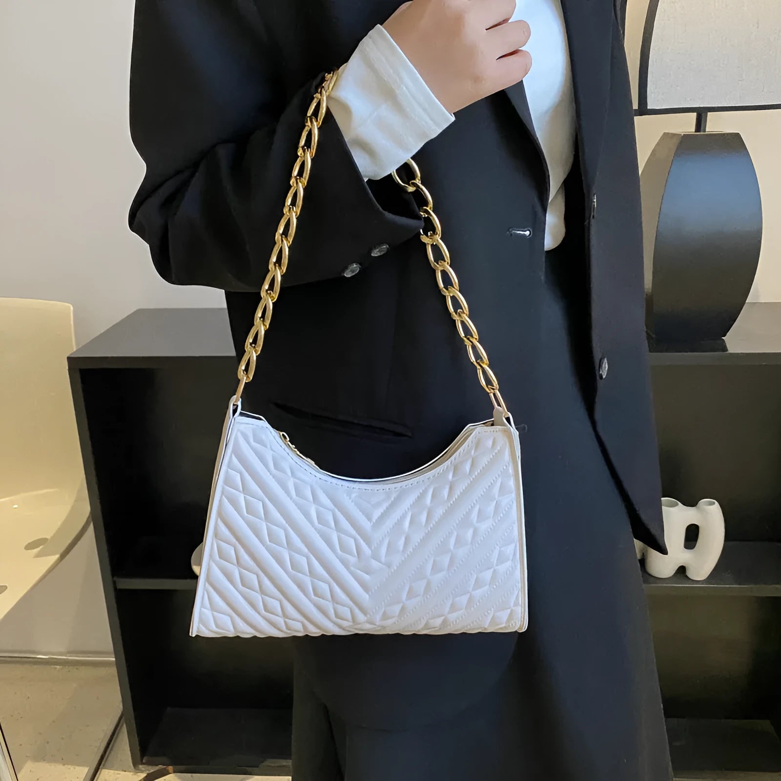 Brown PU pleated chain baguette shoulder bag showing vertical square shape and soft carry handle.