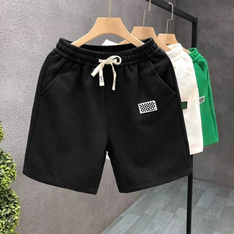 Men's casual sports shorts in polyester fabric showing elastic waistband and solid colour options