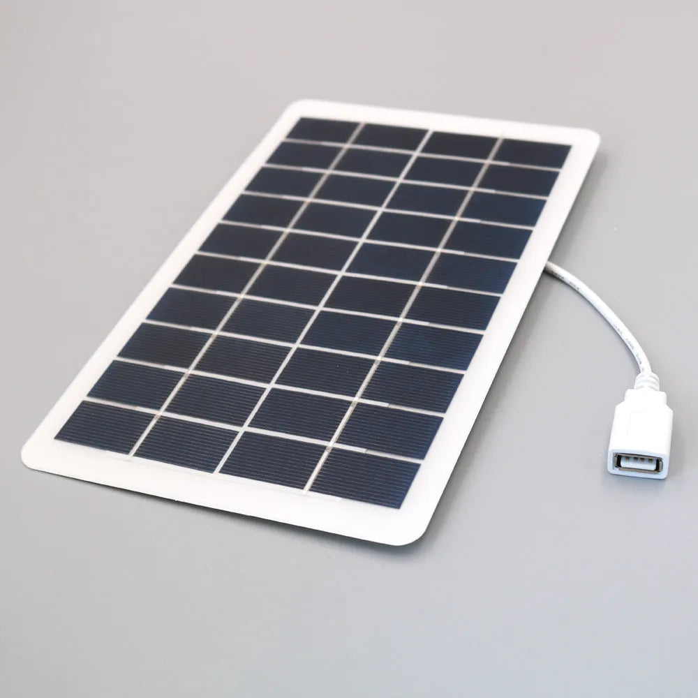 Black portable solar panel charger with USB output for mobile phones