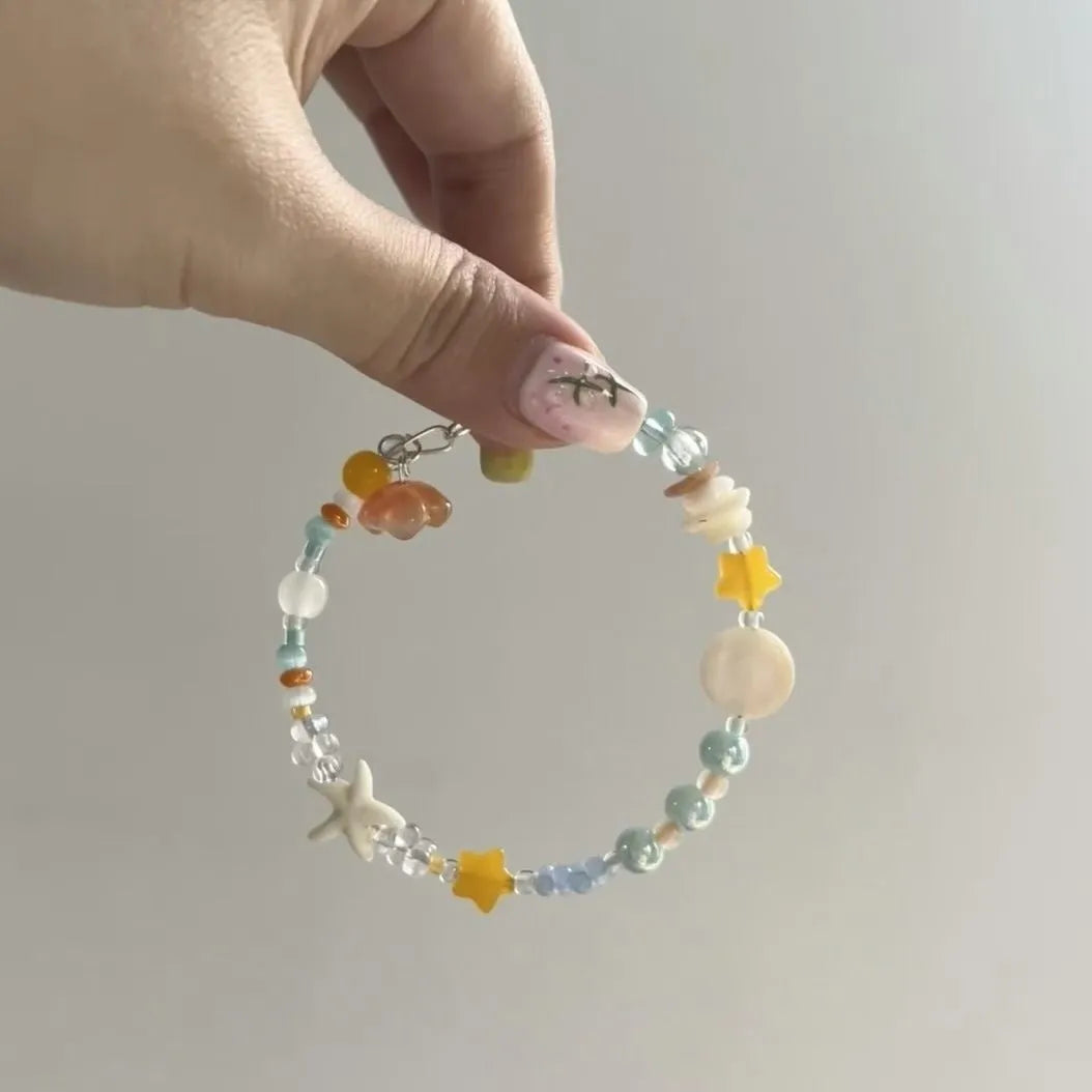 Alloy and mixed material seaside summer charm bracelet in colour Bracelet 0213 with diamond and round shapes.