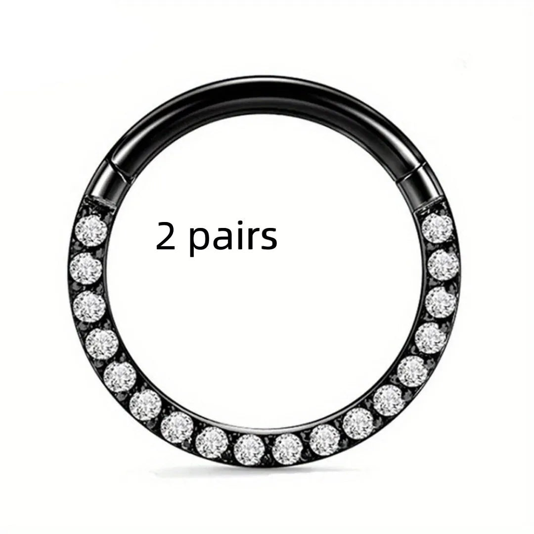 Close-up of a round, seamless stainless steel nose ring in a gold finish, showing its smooth, clasp-free design.