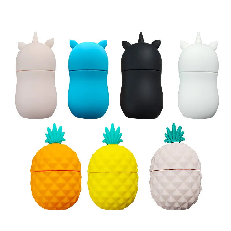 Silicone facial ice mold in pineapple style, pink colour, with ice cubes on a white background