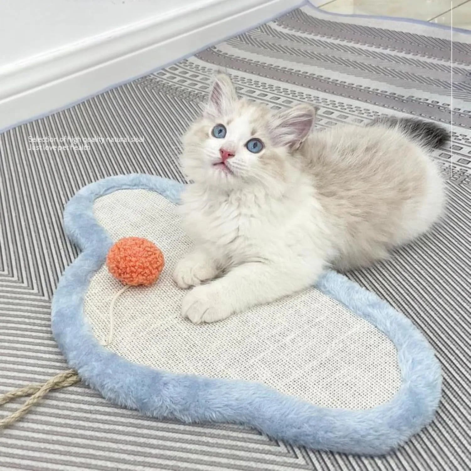 White cat scratching mat with cartoon sleeping cat design, made from natural sisal, shown on a wall.