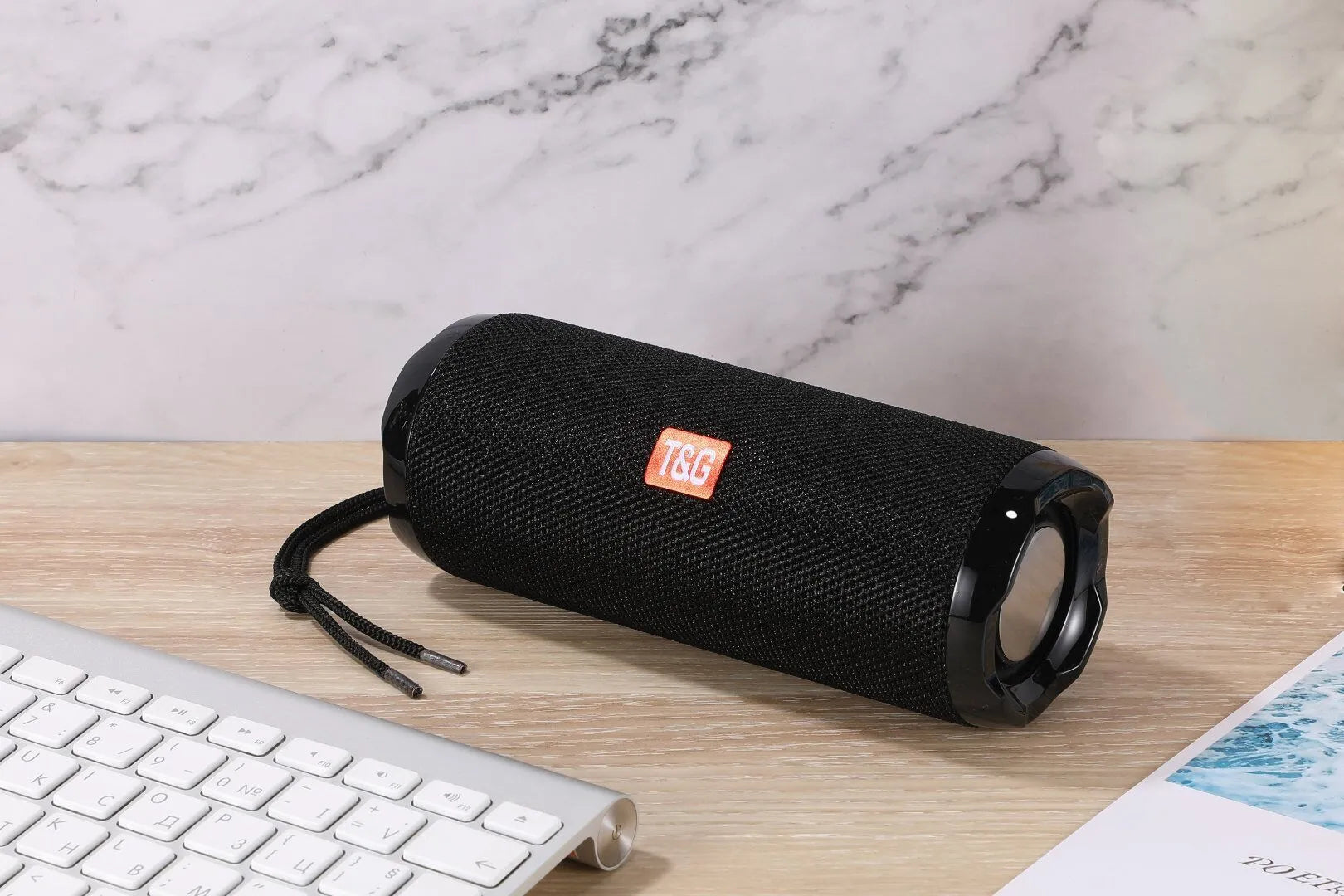 Fabric portable Bluetooth speaker with integrated card holder in multiple colour options.