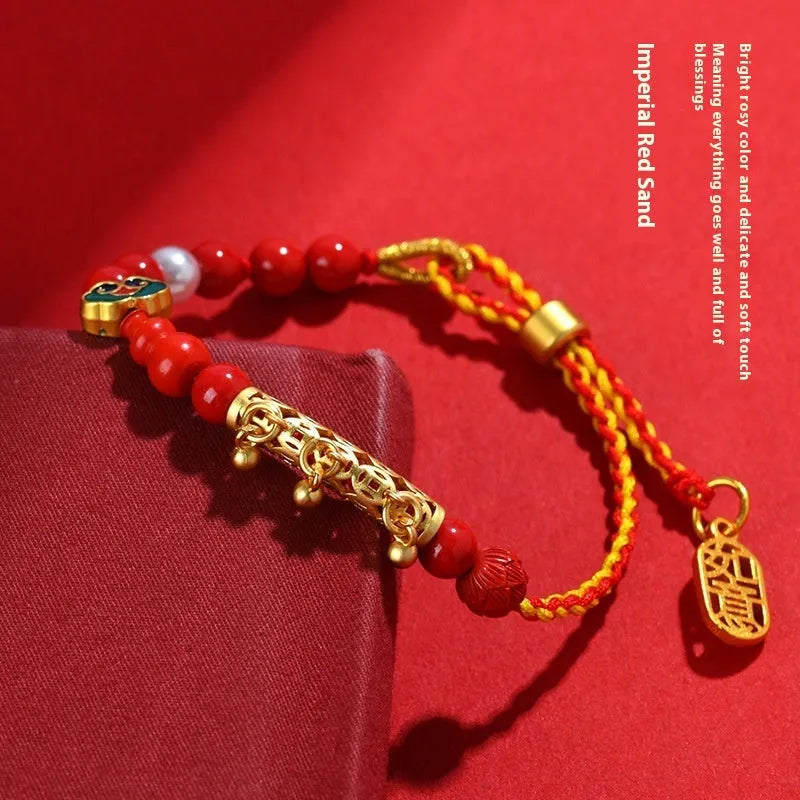 Women's hand-woven cinnabar rope bracelet with round bell charm in emperor red sand colour