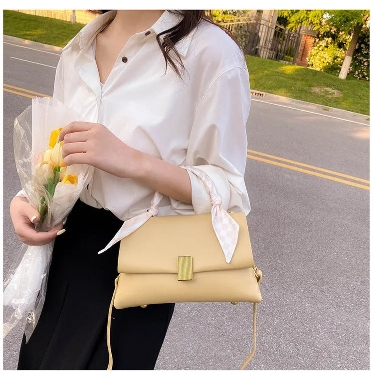 Medium-hardness PU shoulder handbag in horizontal square shape with visible sewing thread detail, black colour option