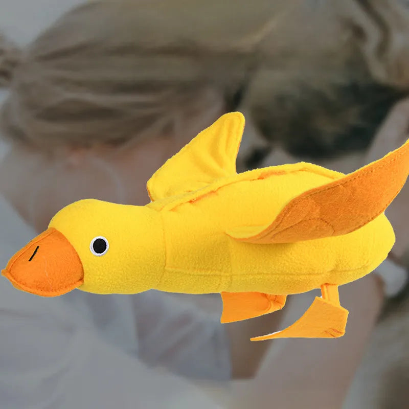 Yellow teddy dog training toy with integrated duck doll and food leak design for scent work
