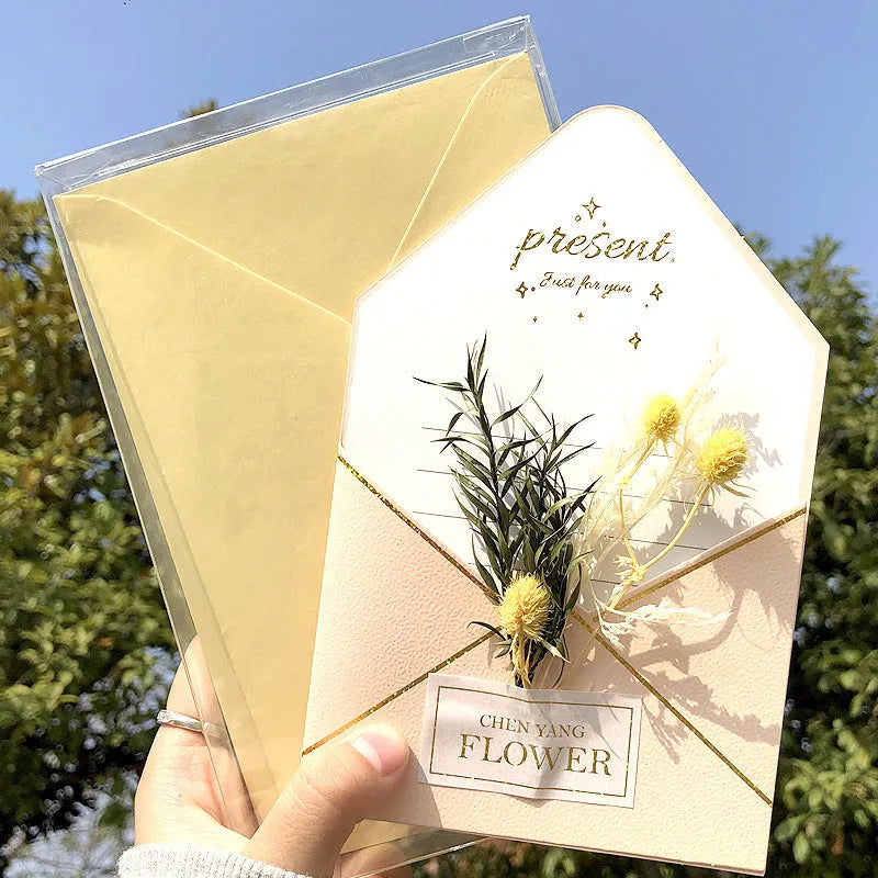Handmade 3D butterfly-shaped greeting card with artificial flowers in a box, alongside its matching envelope.