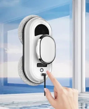 White full-automatic high altitude cleaning machine with remote control on a windowsill