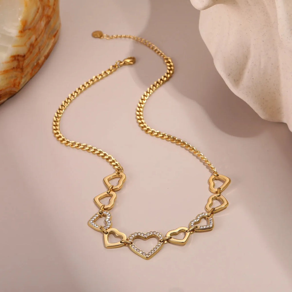 Geometric heart-shaped stainless steel pendant necklace with 18K gold finish on clavicle-length regular chain