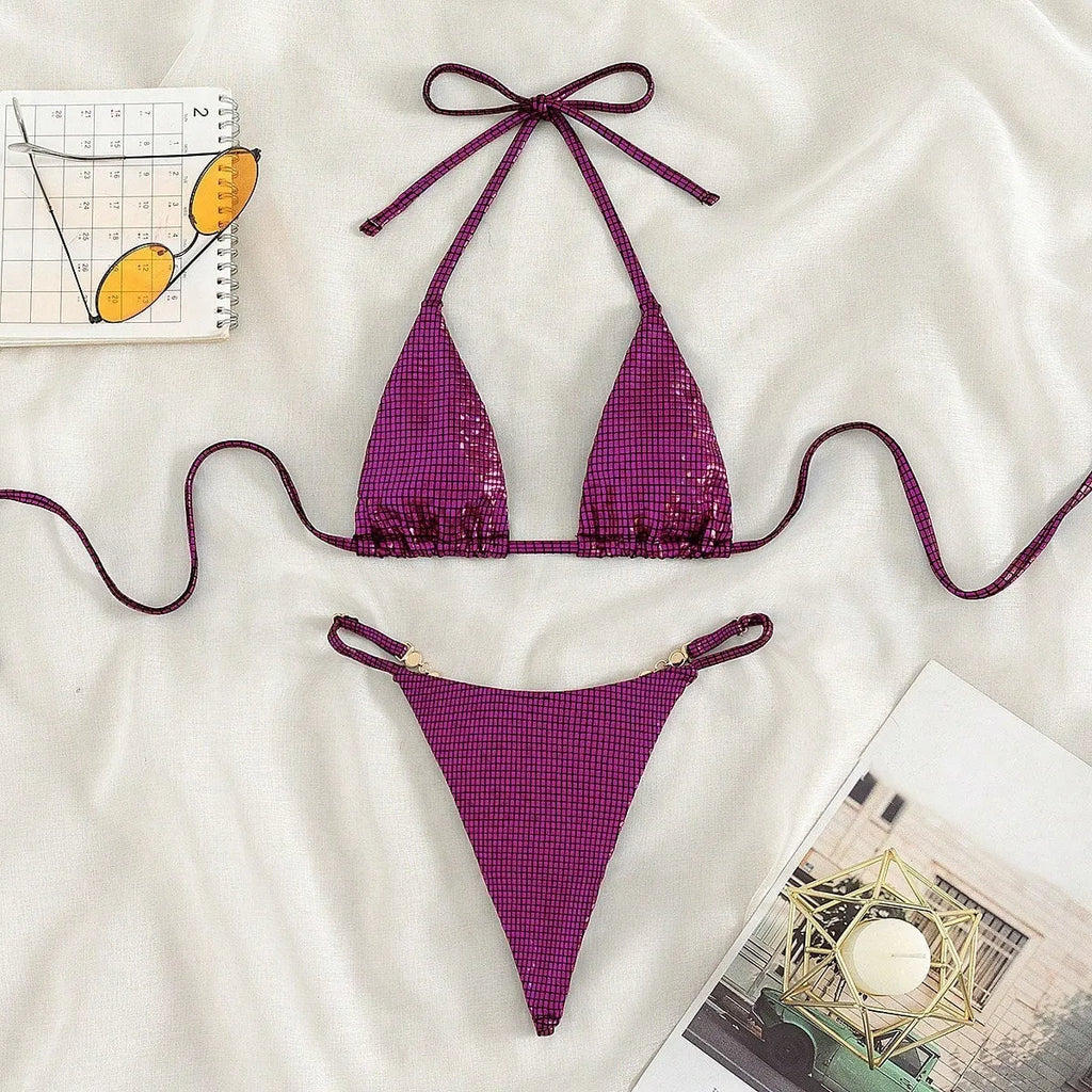 Women's solid colour blue T-back bikini set with briefs, laid flat.