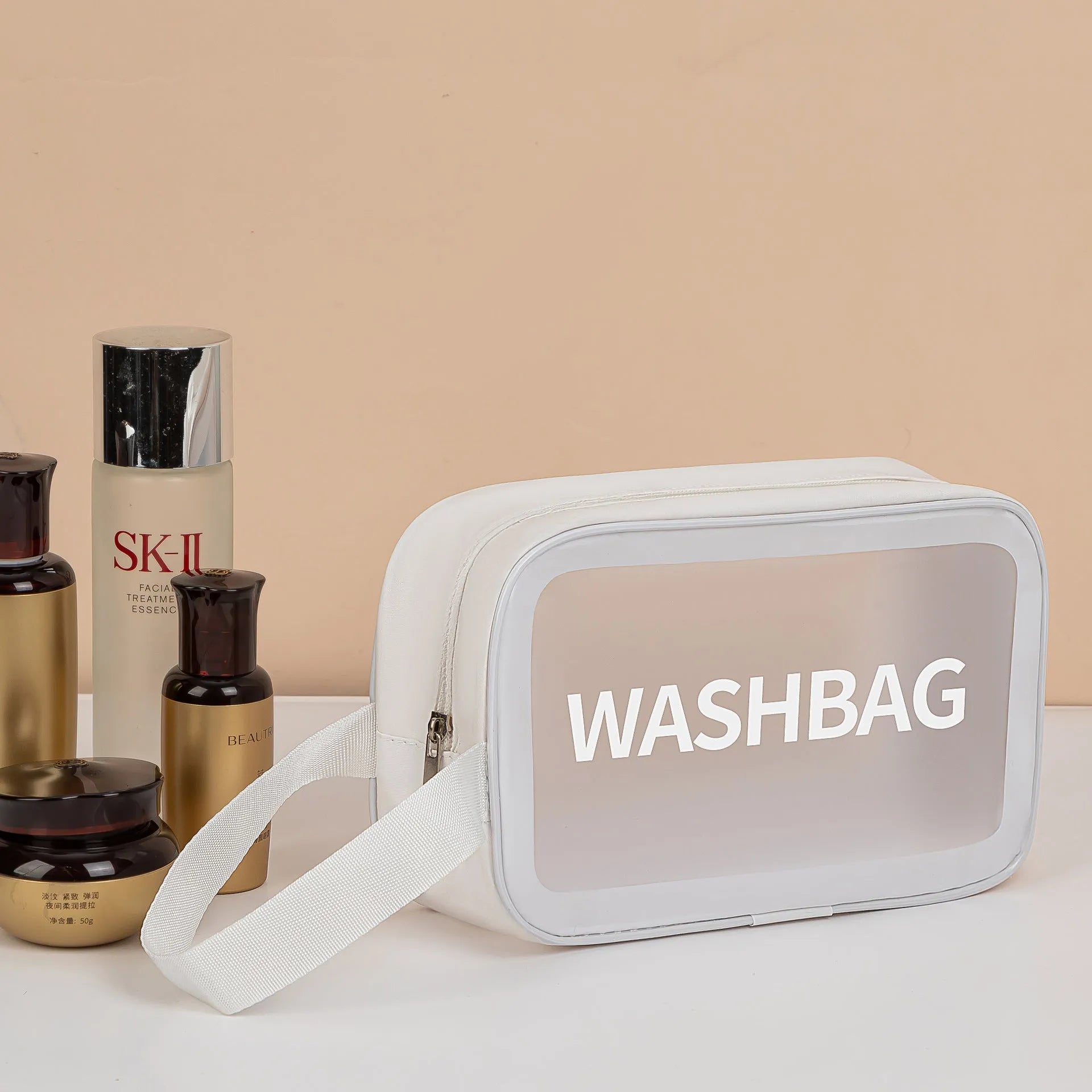Large PVC transparent cosmetic bag three-piece set in various colours including beige, black, blue, pink, and white, empty and open on a flat surface