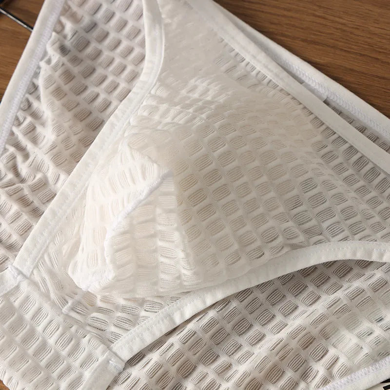 Men's low waist transparent lace underwear in black on a mannequin.