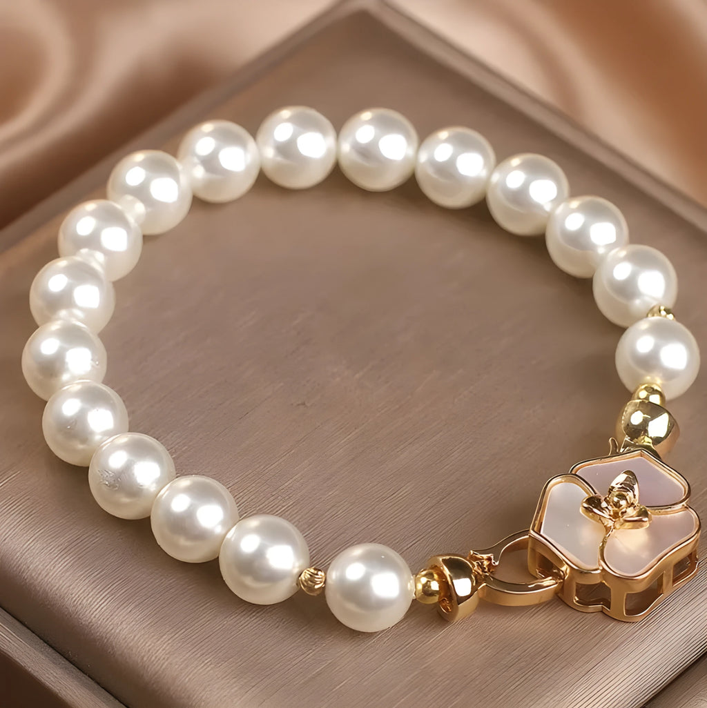 White imitation pearl bracelet with floral French-style design on display for women