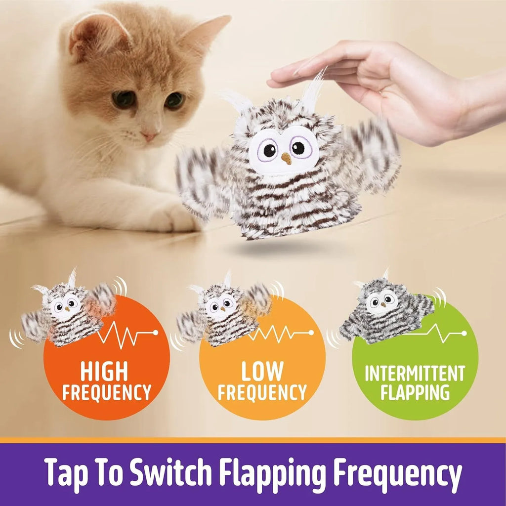Grey automatic chirping owl cat toy with beating wings on a flat surface.