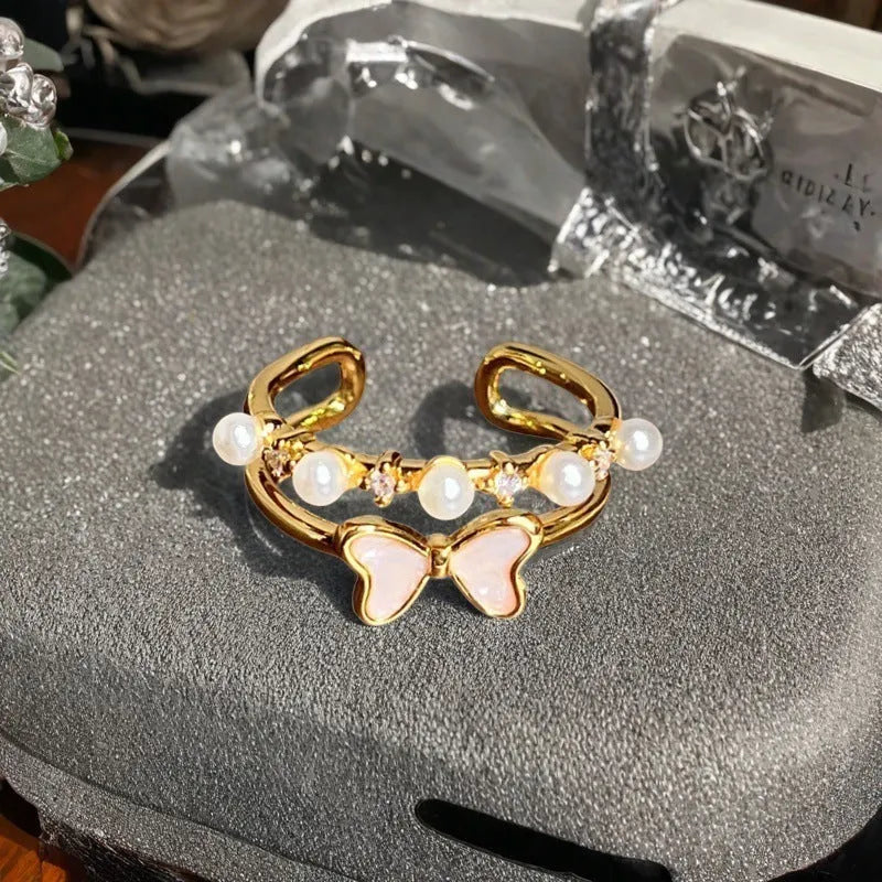 Adjustable copper ring with vintage gourd, flower, and bow design, inlaid with zircon stones.