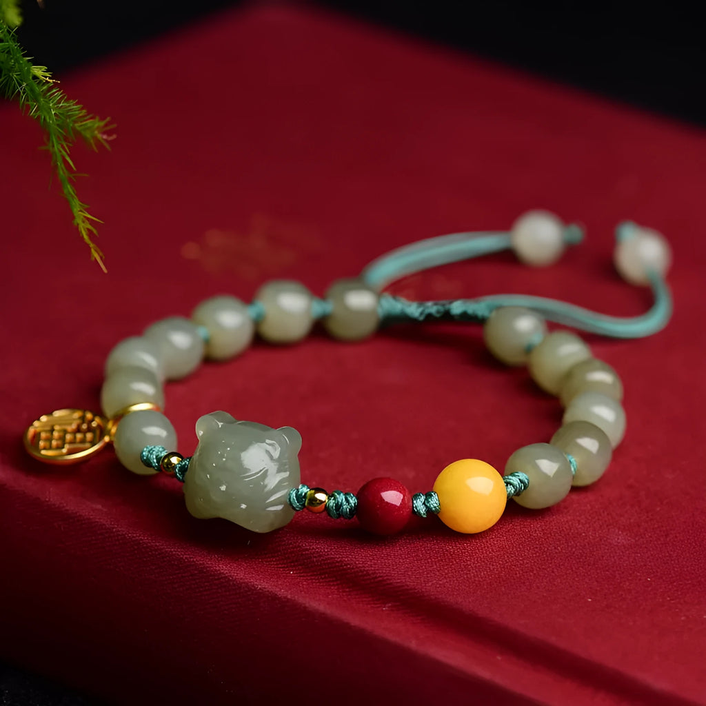 Natural Hetian jade bracelet with cinnabar and beeswax beads featuring animal modelling
