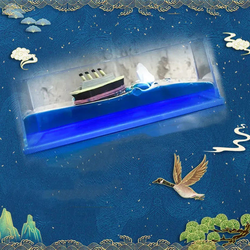 Fluid drift bottle with floating astronaut decoration in acrylic resin, black pearl pirate ship style, on a wooden desk.
