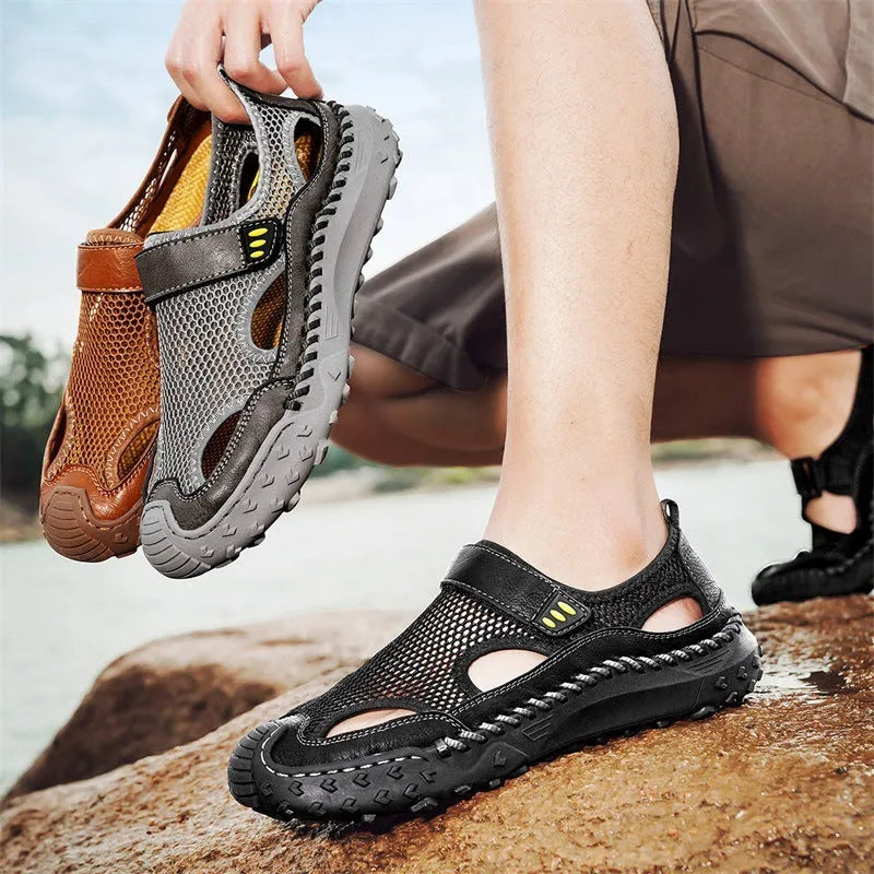 Men's black casual sandals with mesh upper and velcro straps on a rubber sole.