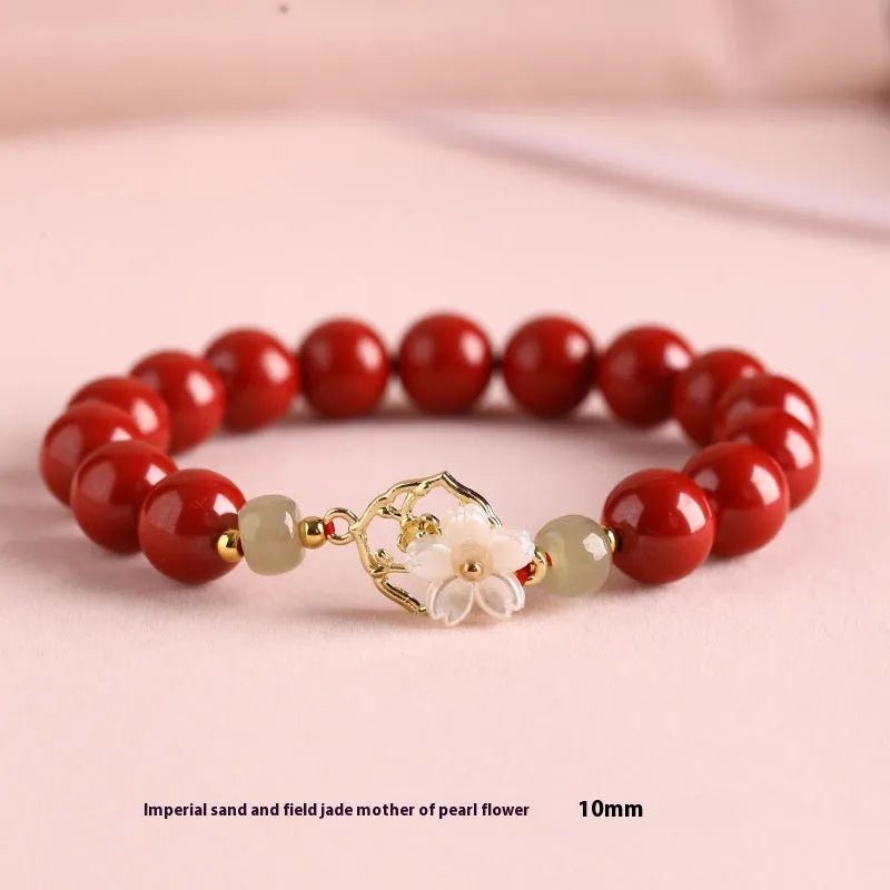 Cinnabar bracelet with Hetian Jade lotus charm and Bells of Ireland accents in New Chinese style