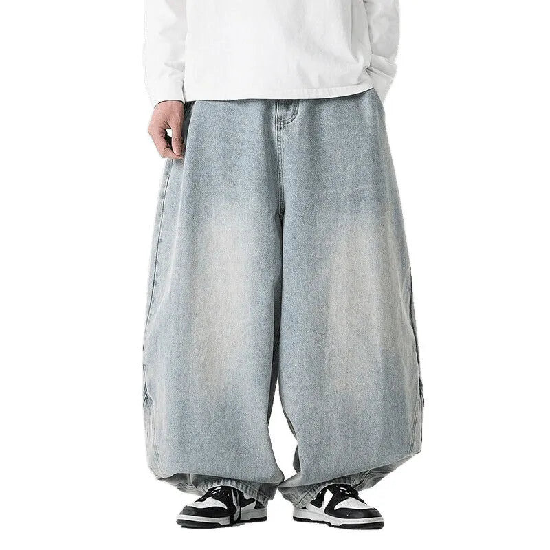 Men's plus-size light blue wide-leg baggy denim jeans on a hanger.