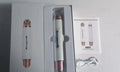Piano white eye beauty instrument with USB cable, showing negative ion and ultrasonic wave modes