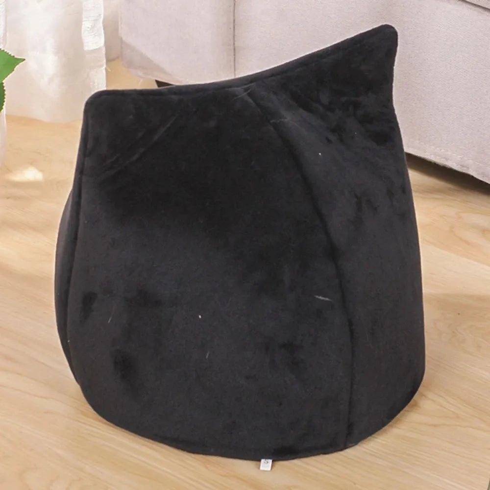 Grey cat-shaped covered pet bed with a removable cushion, shown on a wooden floor.