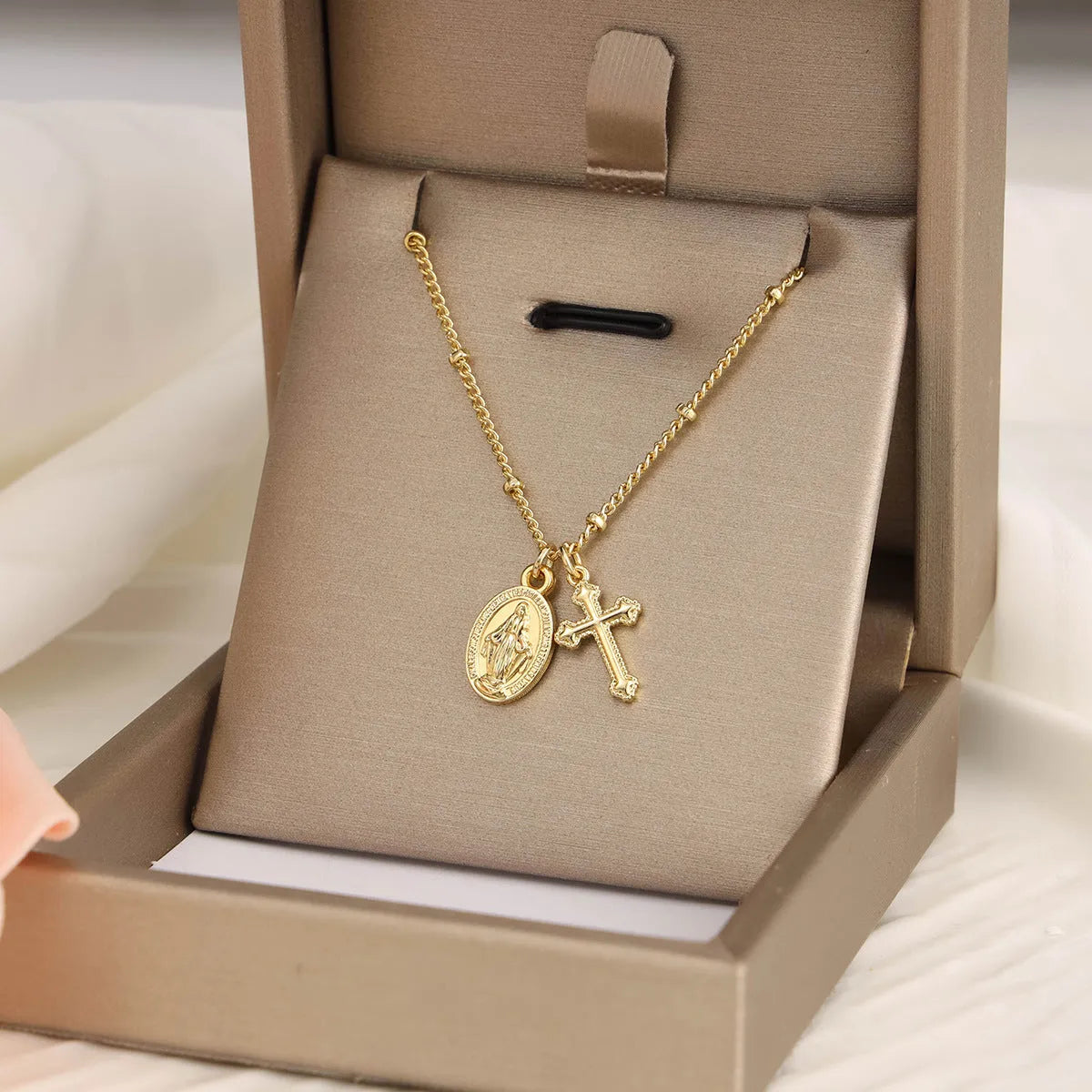 Geometric Virgin Mary cross pendant necklace in gold colour on a chain
