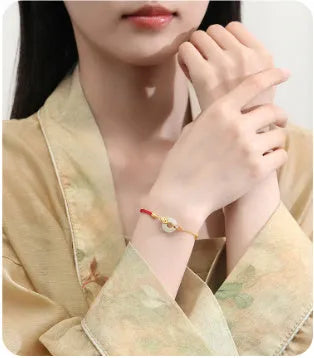 925 sterling silver red rope bracelet with a gold koi peace buckle safety clasp.