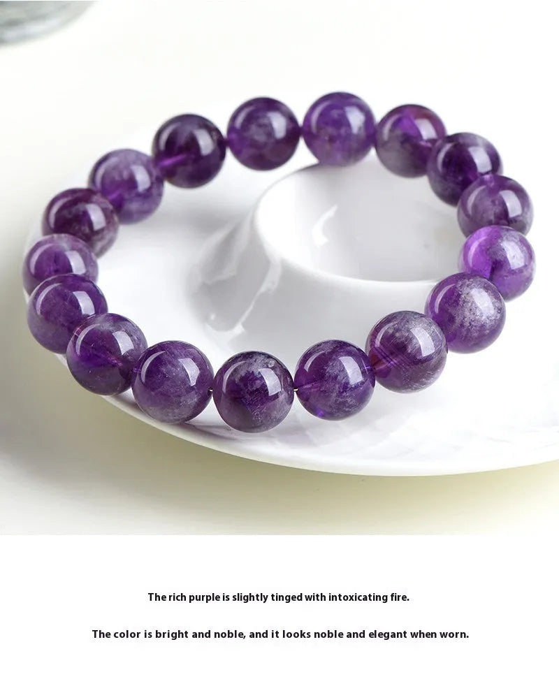Snow Mountain feather amethyst crystal bracelet with scattered geometric beads and Ruyi element.