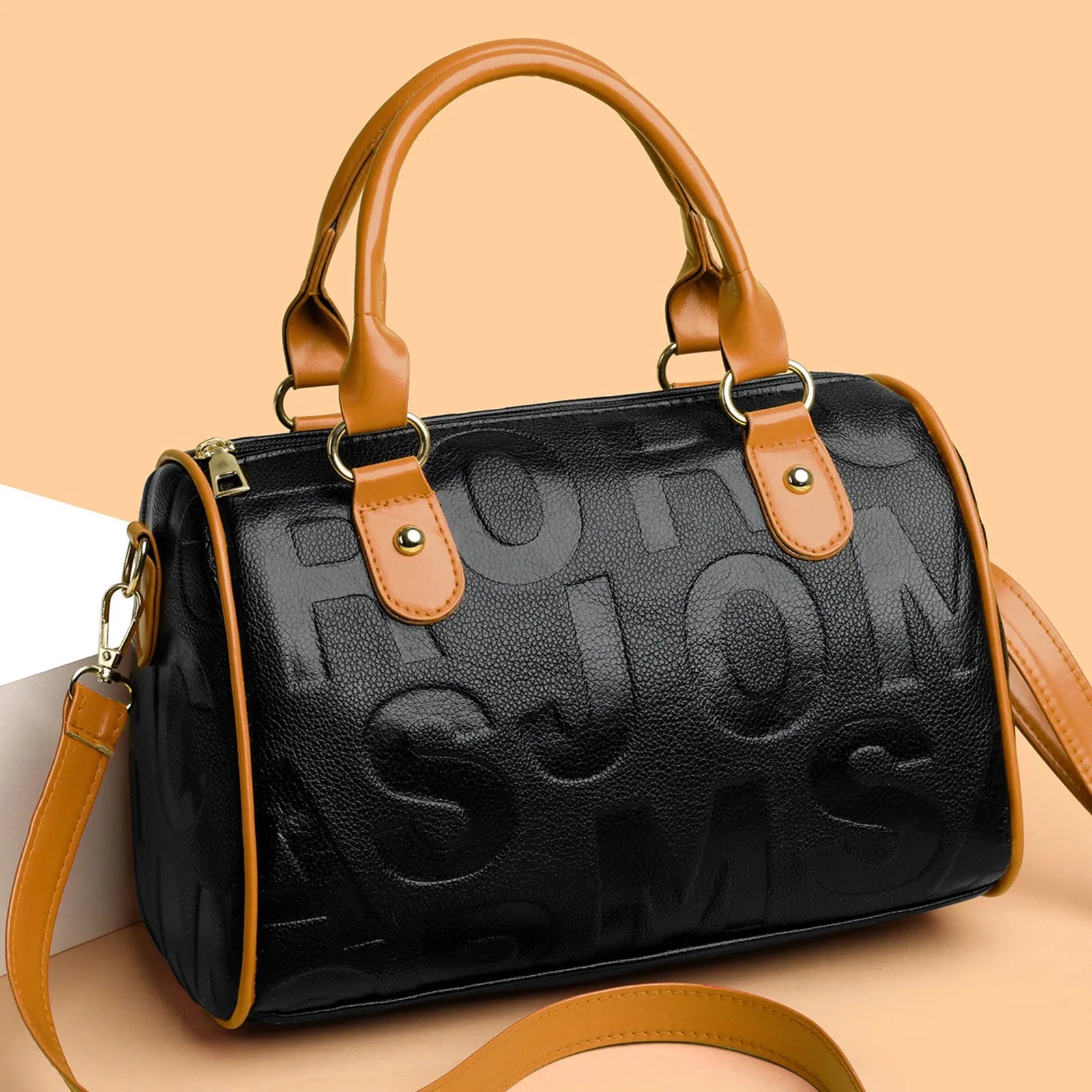 Brown cylindrical PU crossbody bag with a leather-like texture and three shoulder straps.
